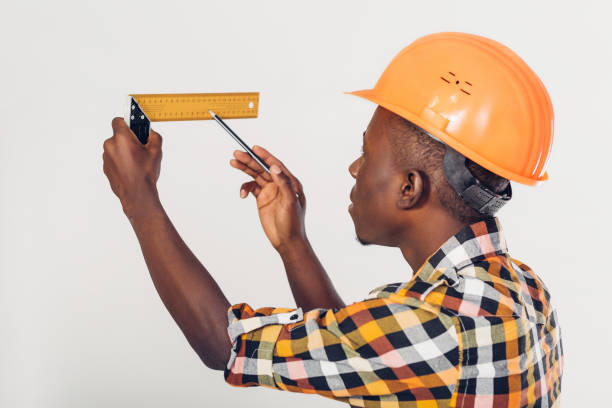 istock African-American builder uses measuring tape 928377348