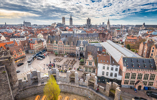 Aerial panoramic view of the historic city of Ghent with famous medieval Gravensteen Castle on a beautiful sunny day with blue sky and clouds in summer, province of East Flanders, Belgium
