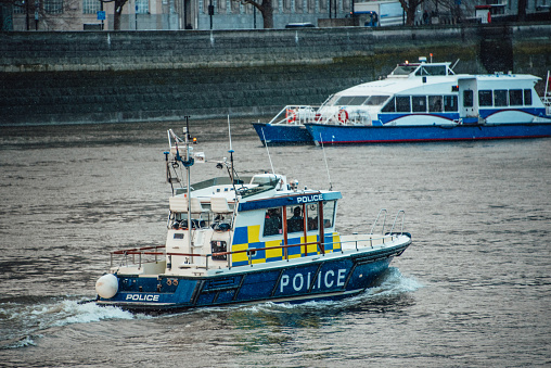 A river Police boat in the thames river. London, UK.