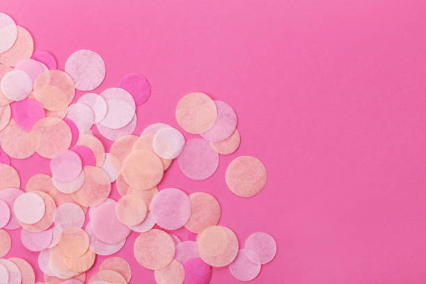 istock Pink confetti on pastel  background. Festive background  for your design. 928394700