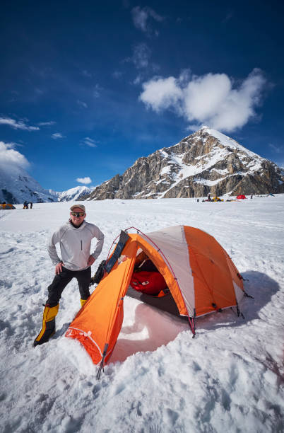 istock Mountaineer standing in front of his tent on Denali 928395996