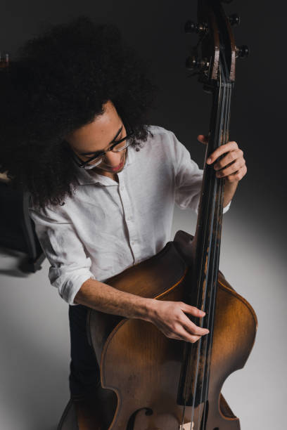 istock high angle view young man playing standup bass 928396022