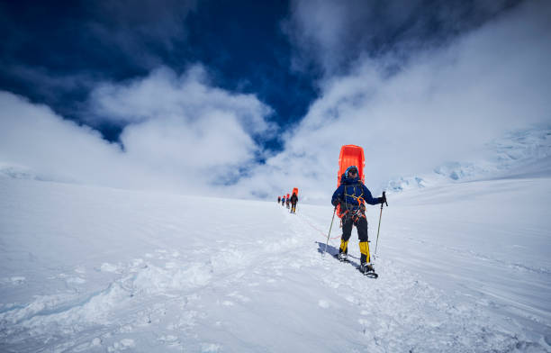 Mountaineers with sledge on his back coming down on Denali.