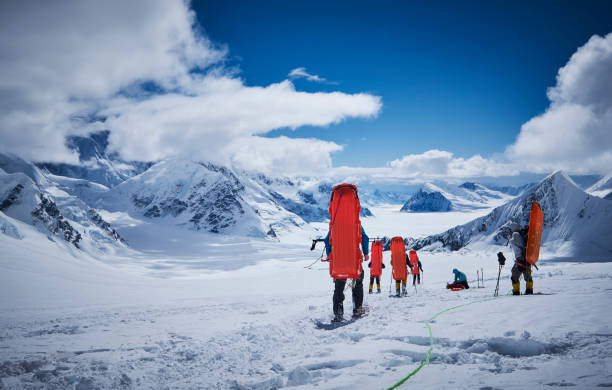 istock Mountaineers with sledge on his back coming down on Denali. 928396358