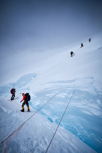 Mountaineers climb the headwall along the fixed ropes on Denali