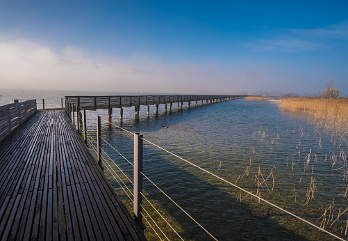 Stunning views of the Holzsteg, a wooden footbridge crossing the Upper Zurich Lake and part of the old Way of Saint James (Jakobsweg, Camino de Santiago) between Rapperswil and Hurden, Sankt Gallen, Schwyz, Switzerland