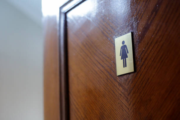 Toilet sign on wooden background