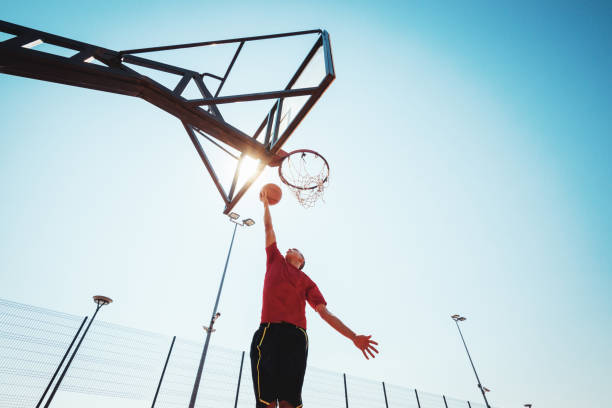istock Young basketball player shows slam dunk 928400234