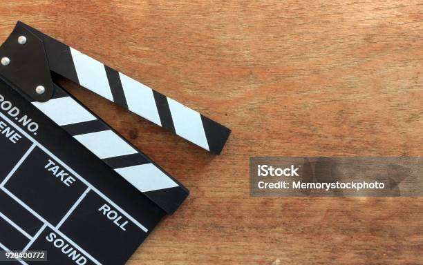 Closeup Movie Clapper Board On Wood Table With Softfocus And Over Light In The Background Stock Photo - Download Image Now