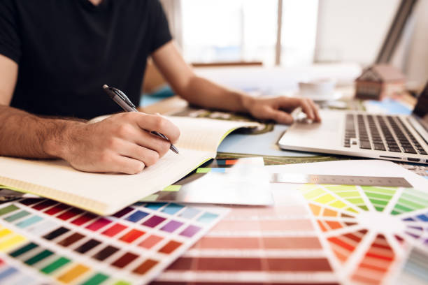 istock Freelancer bearded man taking notes at laptop sitting at desk. 928401308