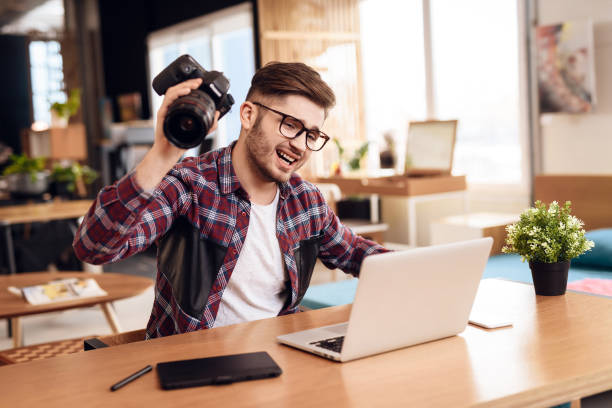 istock Freelancer man frustrated at laptop sitting at desk. 928404188