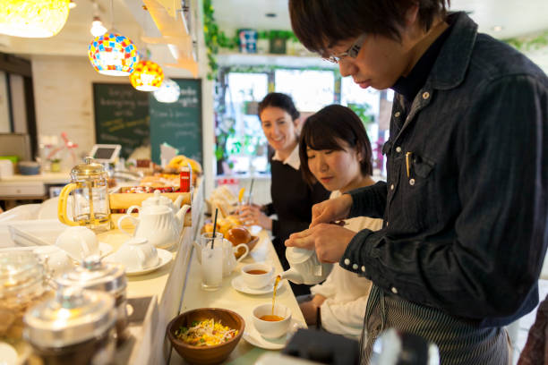 istock Waiter serving drink in cafe 928404224
