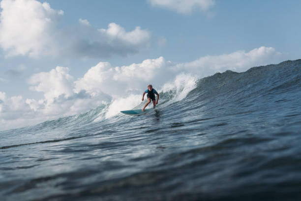 istock male surfer riding wave on surf board in ocean 928404850