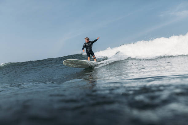 istock man having fun and surfing wave on board in ocean 928407174