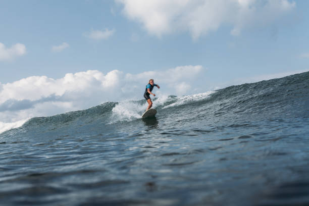 istock man riding wave on surf board in ocean 928407288