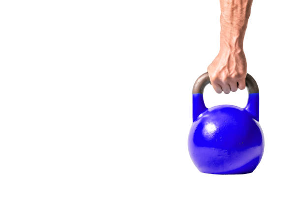 istock Strong muscular man hand with muscles holding dark blue heavy kettlebell partially isolated on white background 928407626