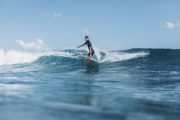istock sportsman surfing wave on surf board in ocean 928410894
