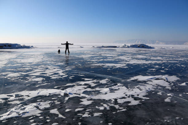 istock A man standing at the ice of Baikal lake 928411952