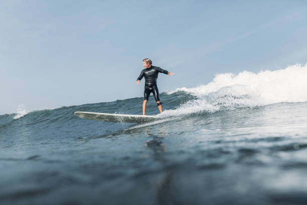 istock surfer having fun and riding wave on surf board in ocean 928414092