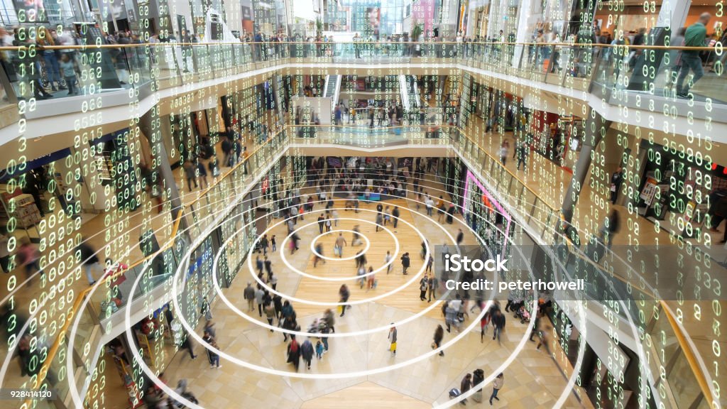 Phone sending out a signal in a matrix styled shopping mall. Radio waves spreading out from a mobile phone in a shopping mall with matrix style data layered on top. Retail Stock Photo