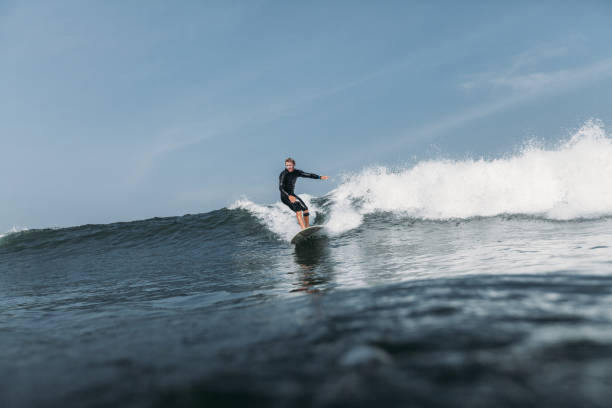 istock surfer having fun and surfing wave on surf board in ocean 928414146