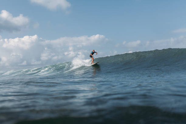 istock surfer riding wave on surf board in ocean 928414366