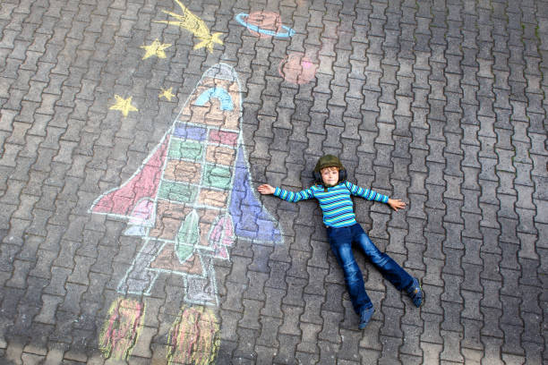istock little kid boy flying by a space shuttle chalks picture 928419126