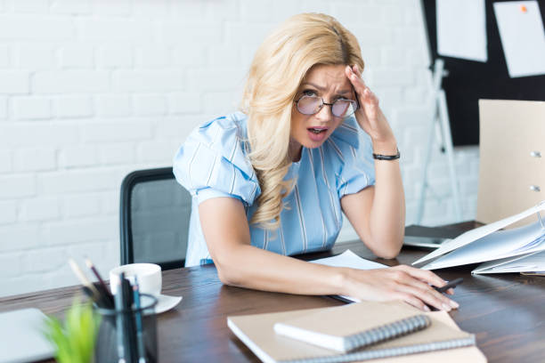 istock businesswoman having headache and looking at camera 928422888