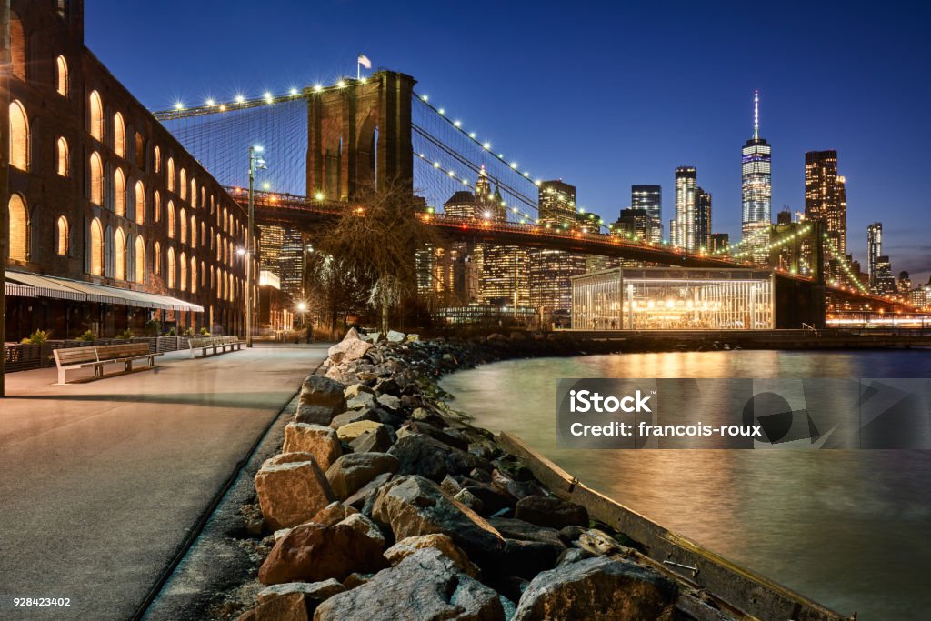 Brooklyn Bridge Park riverfront at twilight with view on the skyscrapers of Lower Manhattan and the Brooklyn Bridge. Brooklyn, New York City Brooklyn Bridge Park riverfront at twilight with view on the skyscrapers of Lower Manhattan and the Brooklyn Bridge. Brooklyn, Manhattan, New York City Brooklyn Bridge Park Stock Photo