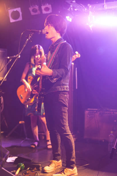 istock Man playing the guitar in club 928426704