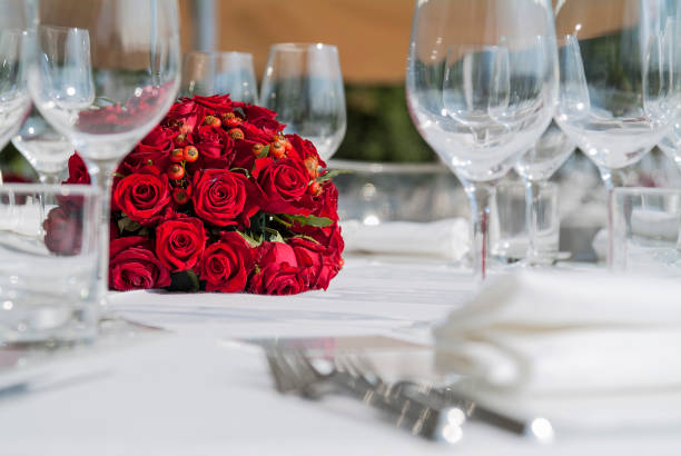 Wedding Setup. Banquet with table and chairs. Decoration, flowers, ware, glass