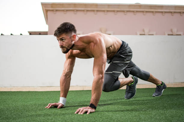 istock Young shirtless muscular man warming up before a workout outdoors. 928427536