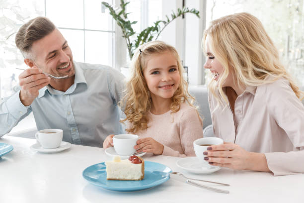 istock beautiful young family spending time in cafe together on weekend 928427876