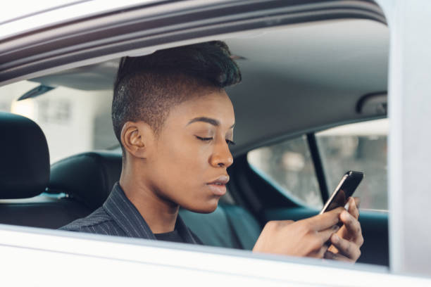 istock black woman on the phone using rideshare 928430880