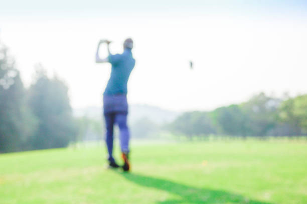 Low angle view of a man putting on a golf course