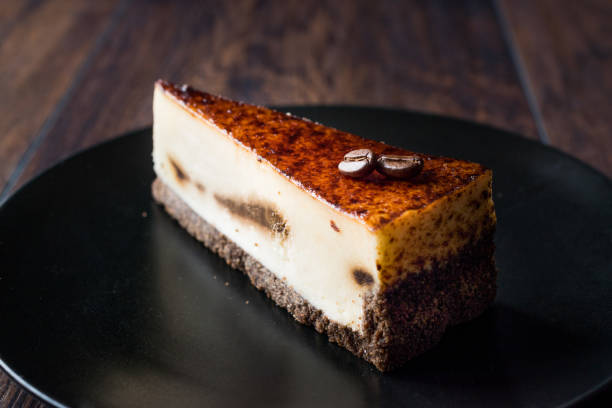 istock Coffee Cheesecake on Black Plate with Dark Wooden Surface. 928433874