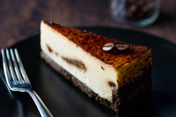 istock Coffee Cheesecake on Black Plate with Dark Wooden Surface. 928434180