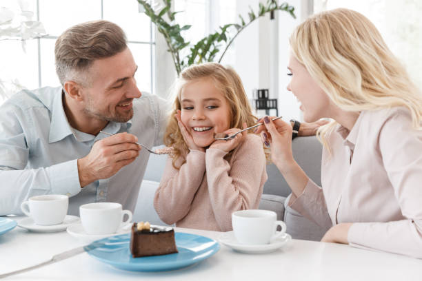istock happy young family having fun together in cafe 928434736