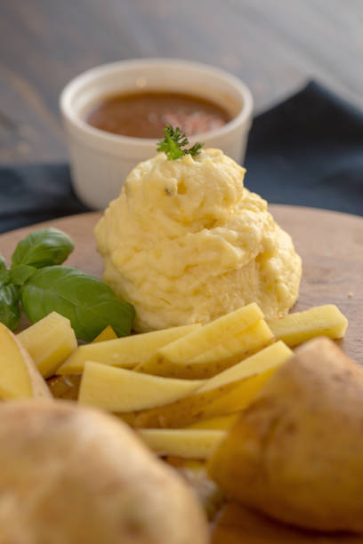 Mashed potatoes in a plate on a wooden table
