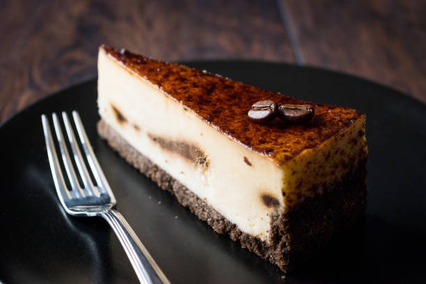 istock Coffee Cheesecake on Black Plate with Dark Wooden Surface. 928438008
