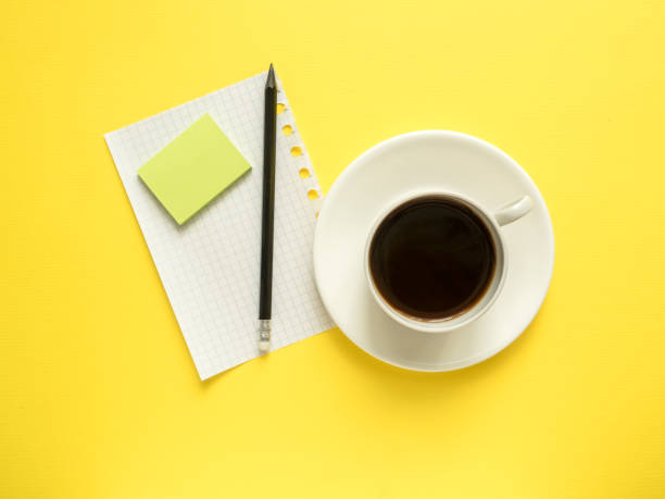 istock Business flat lay with copy space, calculator, pencil, Notepad, coffee glasses on colorful yellow background 928438320