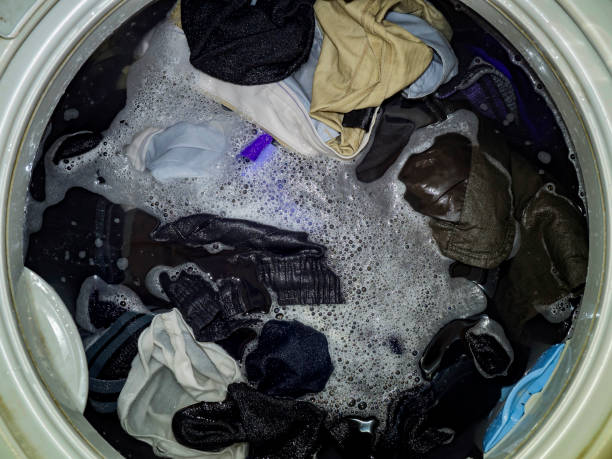 istock Top loading washing machine washes laundry. Internal view of a washing machine drum during wash. Top view. 928438624