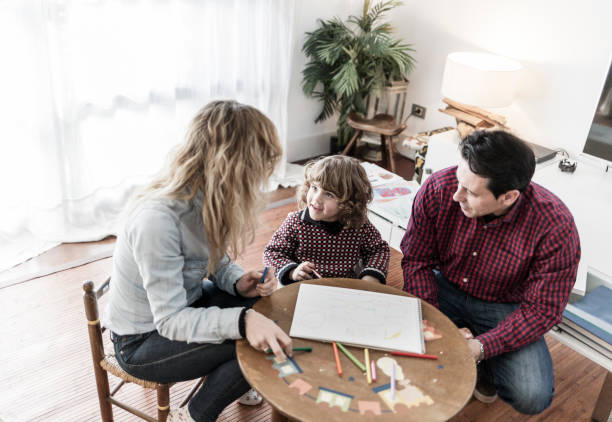 istock Parents drawing with their child at home 928440288
