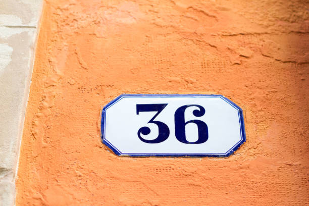 istock Italy: Ceramic Number 36 Street Address Tile; Orange Wall 928441362