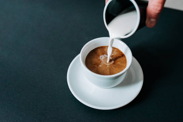 istock Pouring creme in cup of coffee. Close-up. 928441796