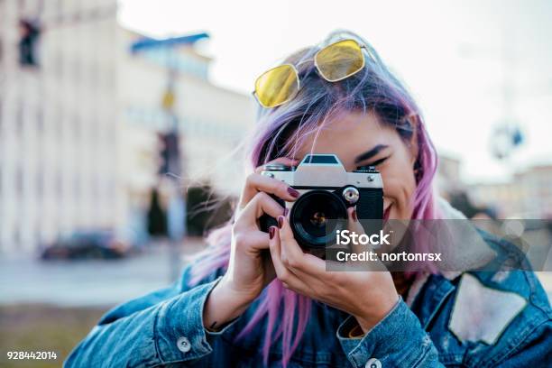 Closeup Image Of Urban Female Photographer Using Camera Stock Photo - Download Image Now