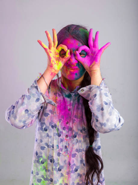 istock girl painted her face with multi colors 928442162
