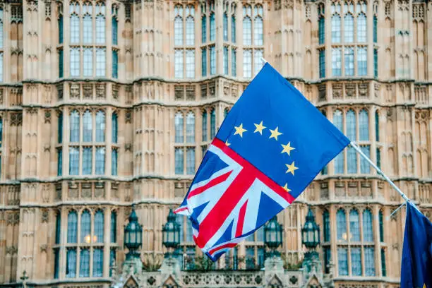 A flag merging the UK and EU flags, by Houses of Parliament building in London