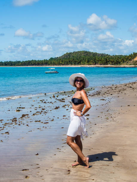 istock attractive woman with hat posing at beach with view on a summer day 928446798