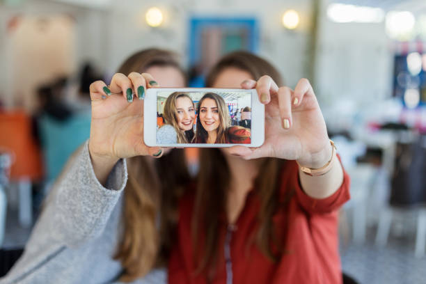 istock Female friends taking a selfie on mobile phone 928450400